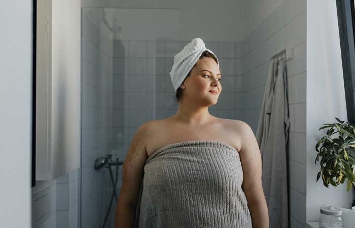 Portrait of a Happy Overweight Woman Standing in the Bathroom after a Relaxing Shower